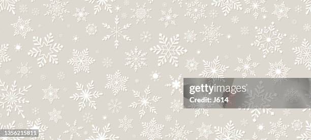 a seamless snowflakes pattern on a light beige background - frozen background stock illustrations