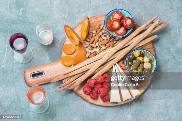 board  with  fruit cheese and breadstick - antipasto fotografías e imágenes de stock