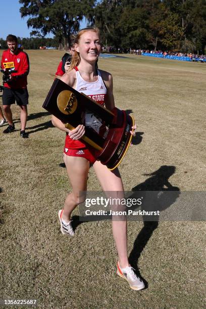 Alexandra Hays of the NC State Wolfpack celebrates with the trophy after winning the Division II Women's Cross Country Championship held at Apalachee...