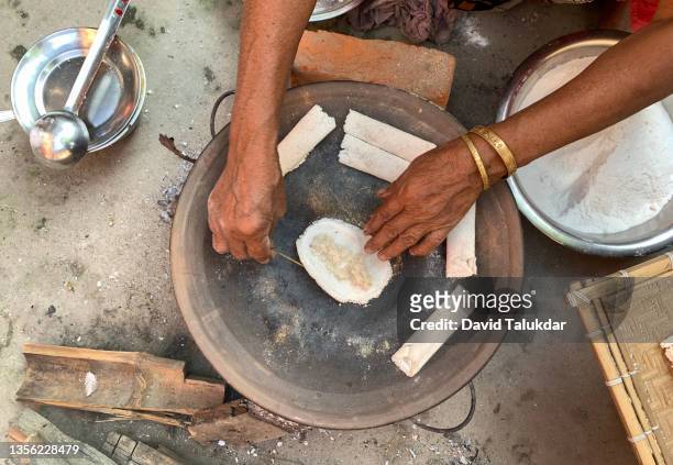 making assamese traditional rice cake - bihu stock pictures, royalty-free photos & images