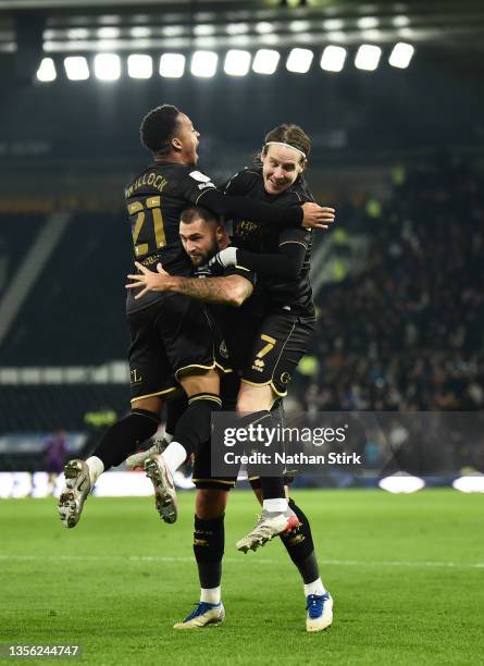 Chris Willock of Queens Park Rangers celebrates with Charlie Austin and Stefan Johansen after he scores their first goal during the Sky Bet...