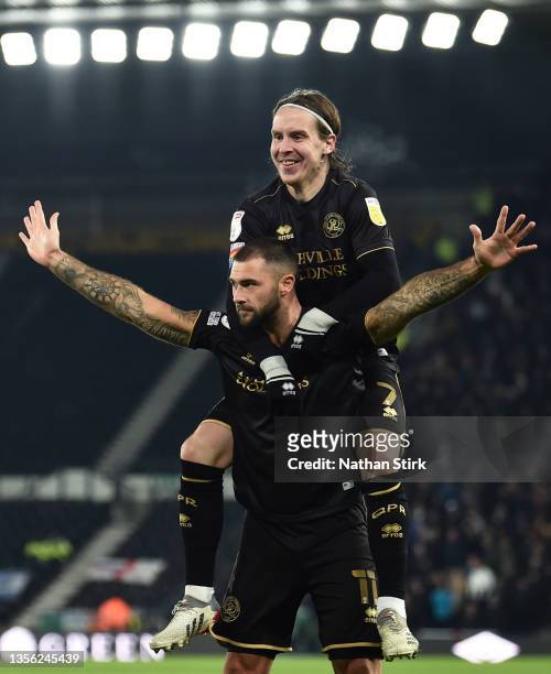 Charlie Austin and Stefan Johansen of Queens Park Rangers celebrate after Chris Willock scores their first goal during the Sky Bet Championship match...