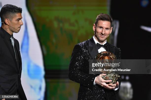 Lionel Messi receives his seventh Ballon D'Or award from Luis Suarez during the Ballon D'Or Ceremony at Theatre du Chatelet on November 29, 2021 in...