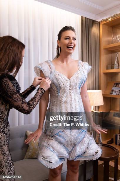 Maria Sharapova getting ready for an event in London wearing a couture Iris van Herpen dress made from recycled evian bottles on November 29, 2021 in...