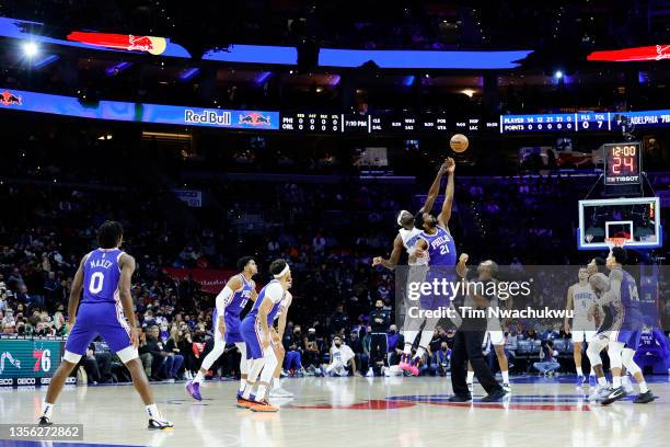 Mo Bamba of the Orlando Magic and Joel Embiid of the Philadelphia 76ers tip-off at Wells Fargo Center on November 29, 2021 in Philadelphia,...