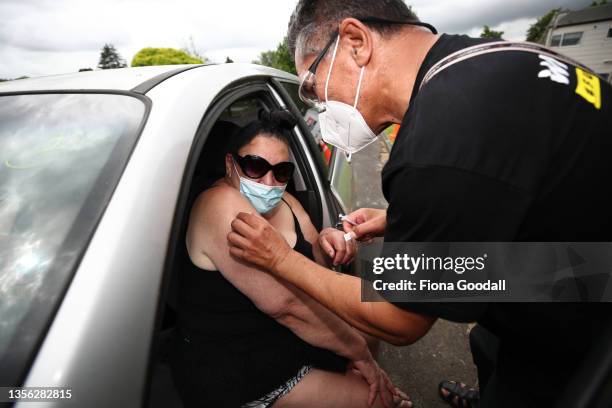 Shirley Te Puke gets her first Covid-19 vaccine from John Ormsby, a lay vaccinator with the Te Whanau O Waipareira vax team. The team are helping...
