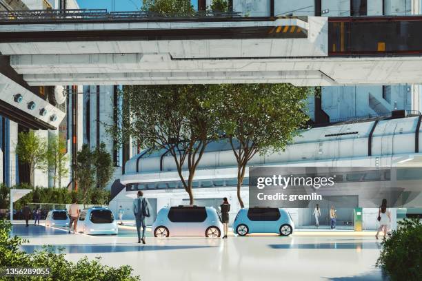 futuristic city center with electric vehicles and people - landvoertuig stockfoto's en -beelden