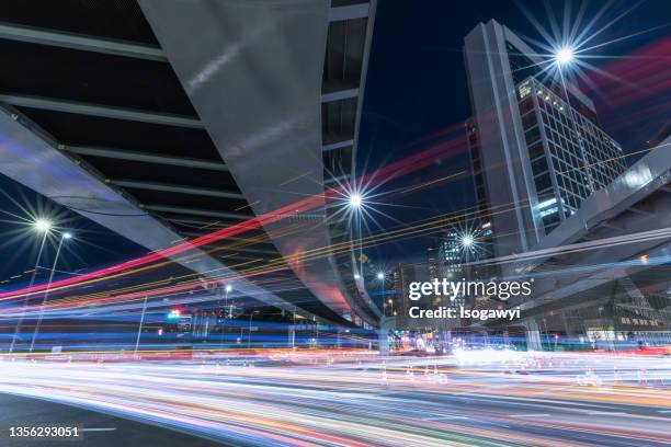 busy junction light trails in tokyo - minato stock pictures, royalty-free photos & images