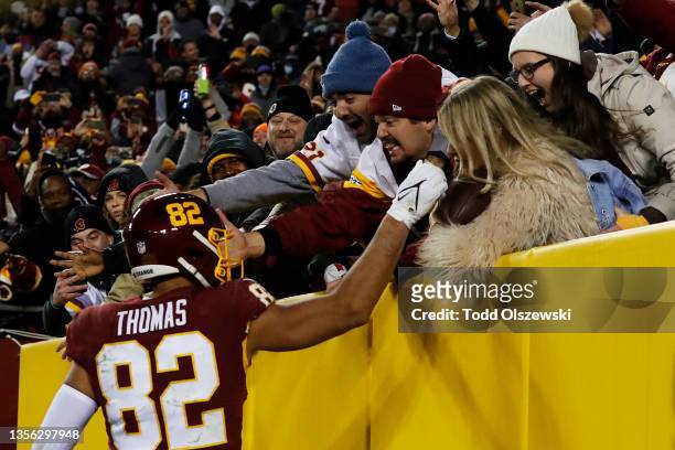 Logan Thomas of the Washington Football Team celebrates his touchdown against the Seattle Seahawks with fans during the fourth quarter at FedExField...