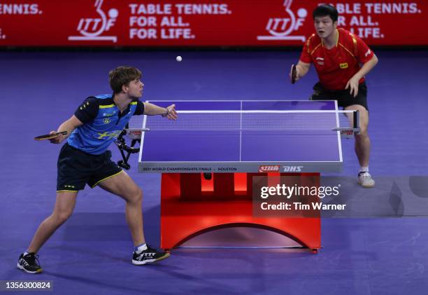 Truls Moregard of Sweden serves to Fan Zhendong of China during the men's singles finals match of the 2021 ITTF World Table Tennis Championships at...