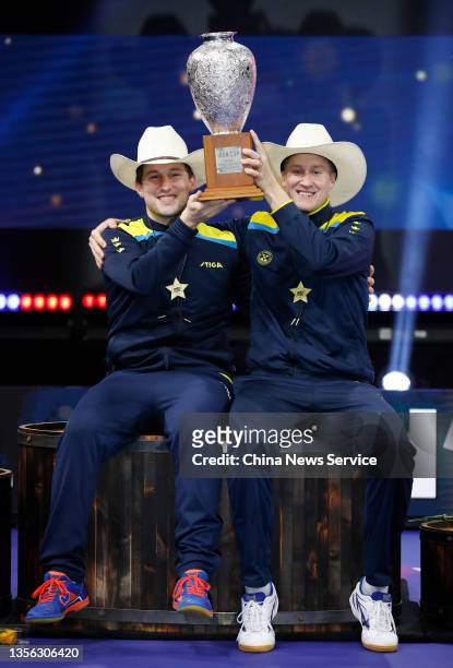 Kristian Karlsson and Mattias Falck of Sweden pose with their champion trophy after winning the Men's Doubles final match against Jang Woojin and Lim...