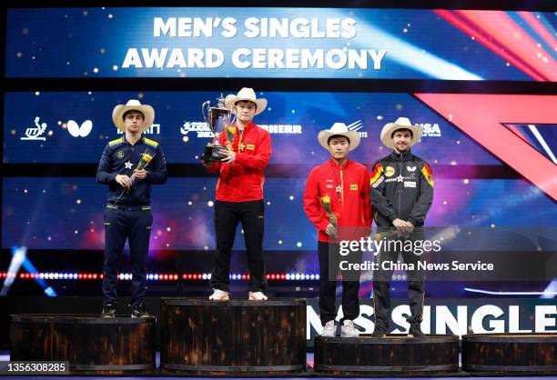 The runner-up Truls Moregard of Sweden, winner Fan Zhendong of China, the third places Liang Jingkun of China and Timo Boll of Germany pose during...