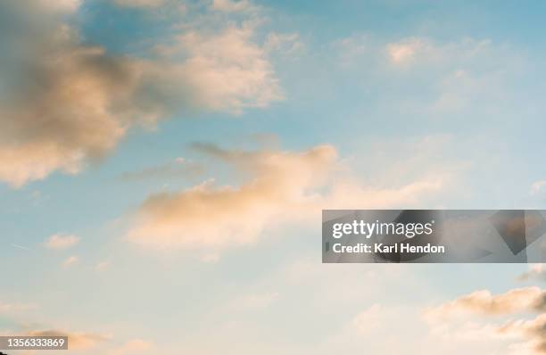 a view of pink clouds against a blue sky at sunset - stock photo - escena de tranquilidad fotografías e imágenes de stock