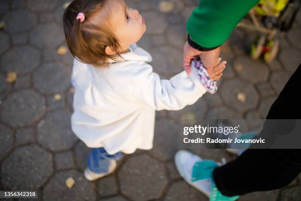 mother and baby walking outside - cute adult baby girls stock pictures, royalty-free photos & images