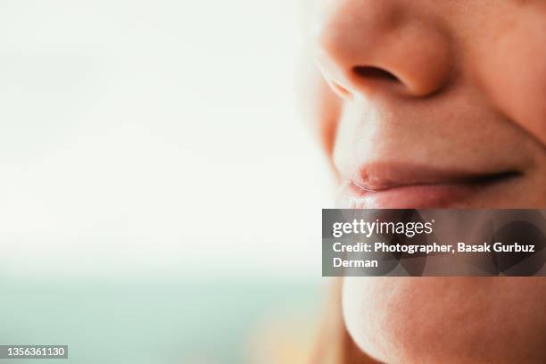 cropped shot of a woman smiling - human nose stockfoto's en -beelden