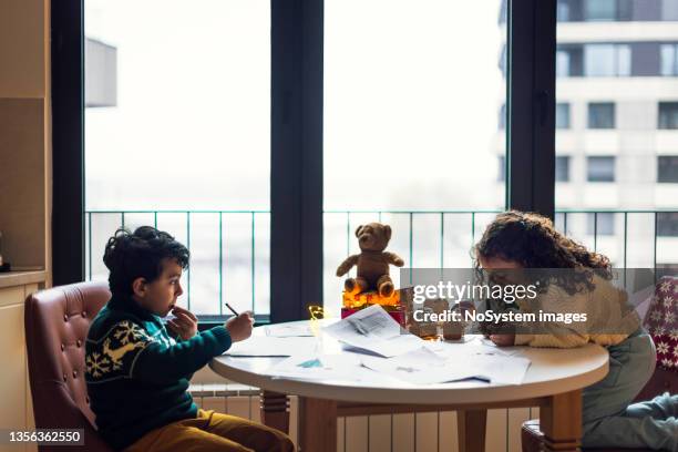 siblings writing christmas wish - child writing letter to santa stock pictures, royalty-free photos & images