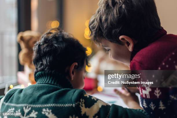 siblings writing christmas wish - child writing letter to santa stock pictures, royalty-free photos & images