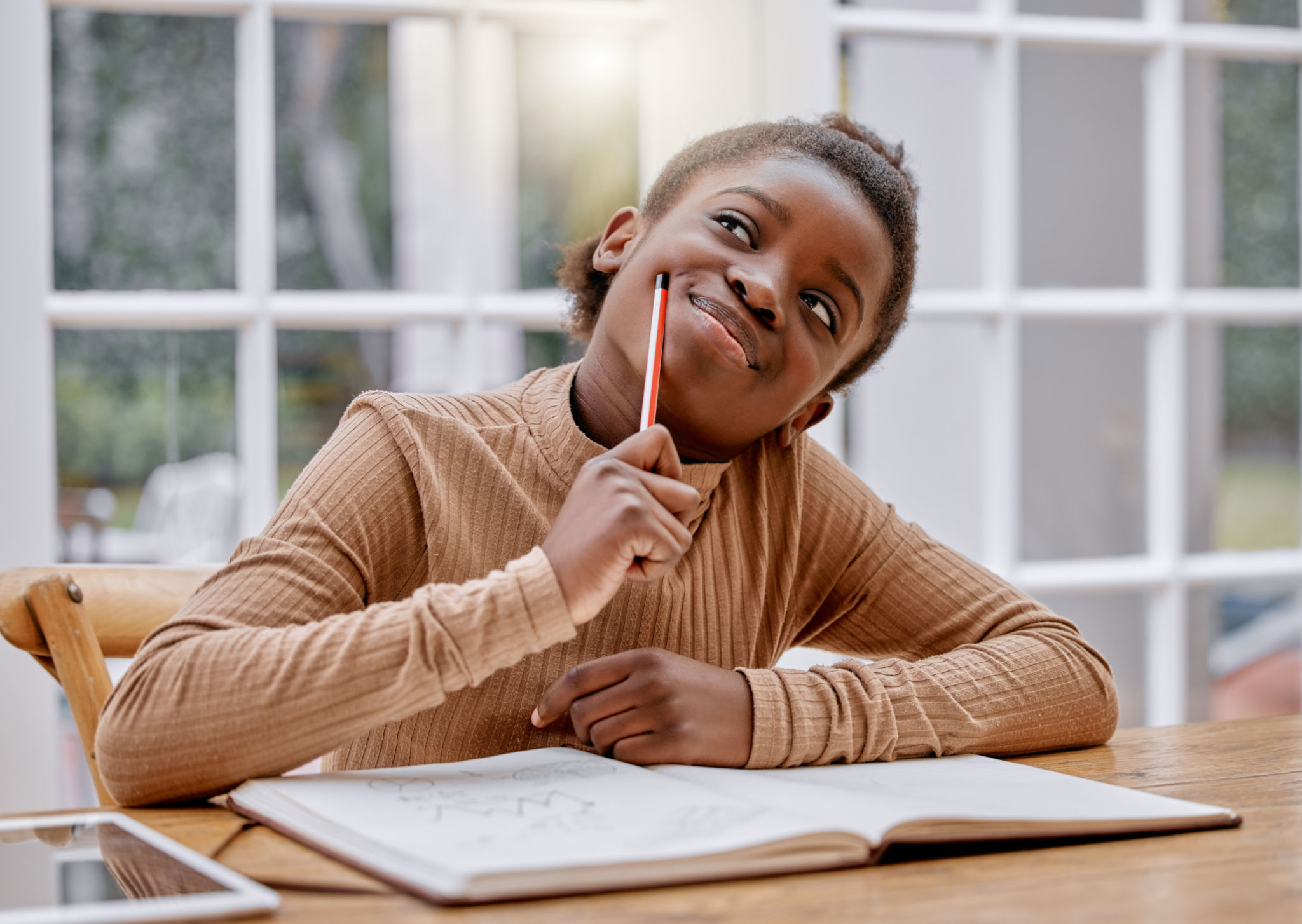 Shot of a little girl doing homework at home Shot of a little girl doing homework at home