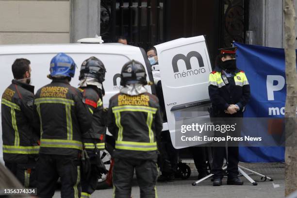 Officers guard the hearse at the scene of a fatal house fire in Plaza de Tetuan, on 30 November, 2021 in Barcelona, Catalonia, Spain. At least four...