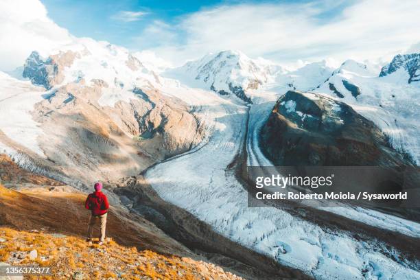 person admiring monte rosa and gorner glacier, switzerland - alpi foto e immagini stock