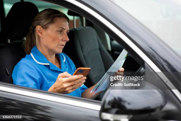 contacting her patients - using phone in car stock pictures, royalty-free photos & images