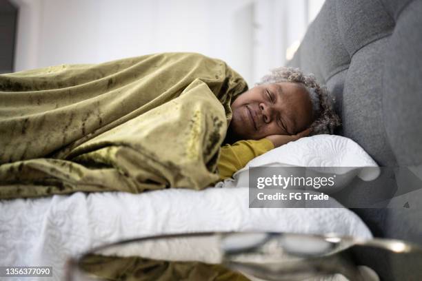 senior woman sleeping at home - comfortable sleeping stock pictures, royalty-free photos & images