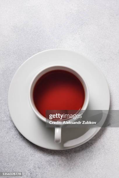 ceramic cup or mug of black tea, isolated on a white stylish modern background or table. - black cup saucer stock pictures, royalty-free photos & images