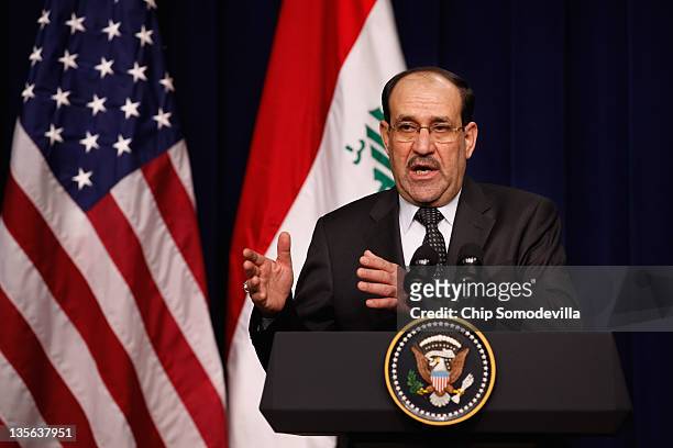 Iraqi Prime Minister Nouri Al-Maliki answers reporters' questions during a news conference with U.S. President Barack Obama in the Eisenhower...