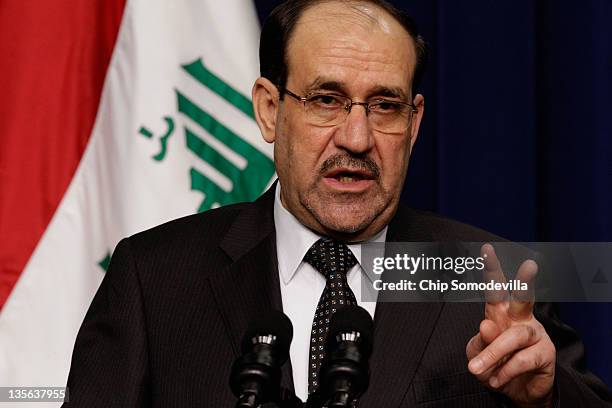 Iraqi Prime Minister Nouri Al-Maliki answers reporters' questions during a news conference with U.S. President Barack Obama in the Eisenhower...