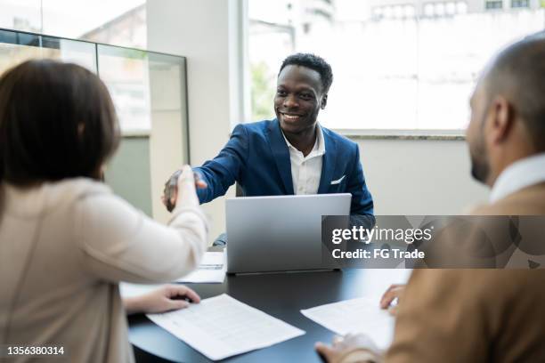 customer shaking hands with car salesman buying a car - customer bildbanksfoton och bilder