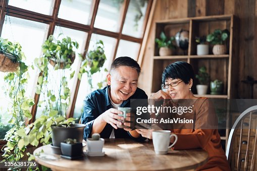 Happy senior Asian couple video chatting, staying in touch with their family using smartphone together at home. Senior lifestyle. Elderly and technology Happy senior Asian couple video chatting, staying in touch with their family using smartphone together at home. Senior lifestyle. Elderly and technology