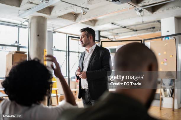 businessman doing a presentation to a team - brazil training and press conference stock pictures, royalty-free photos & images
