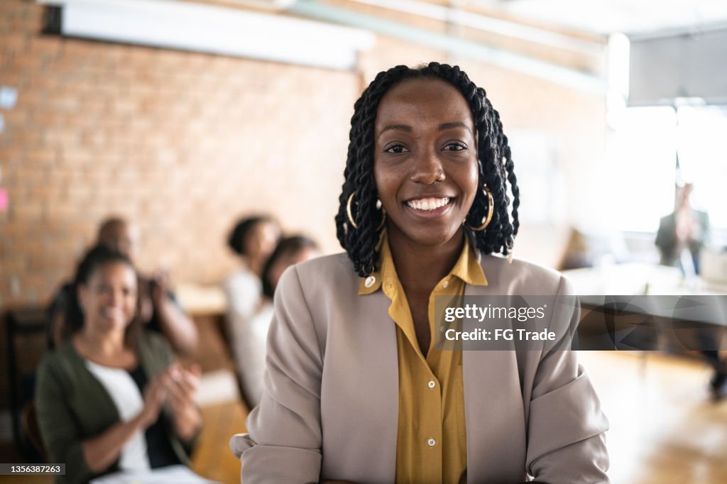 Portrait of businesswoman delivering a speech during a conference