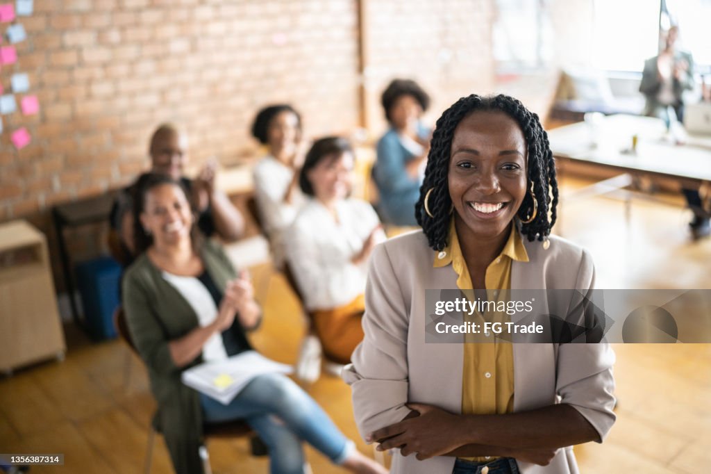 Portrait of businesswoman delivering a speech during a conference