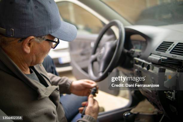 professional car stereo installer working on his last customer's car - auto radio stock pictures, royalty-free photos & images