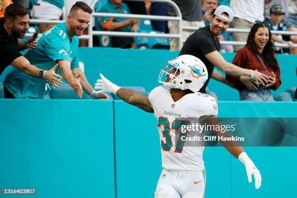 Myles Gaskin of the Miami Dolphins celebrates a touchdown during their game against the Carolina Panthers at Hard Rock Stadium on November 28, 2021...