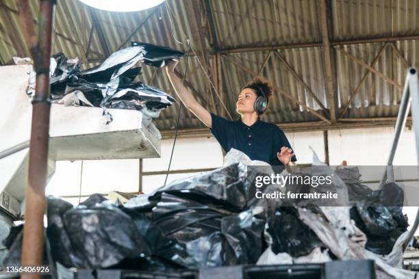 blue collar working in plastic recycling factory - torn clothes stock pictures, royalty-free photos & images