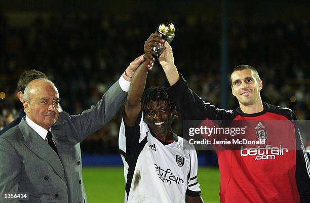 Fulham Chairman Mohamed Al Fayed, Fulham Captain Rufus Brevett and Club Captain Andy Melville celebrate after winning the Intertoto Cup Final Second...