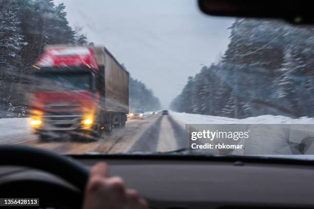 blurred view of traffic of cars and trucks on winter road in snowy weather - blizzard bildbanksfoton och bilder