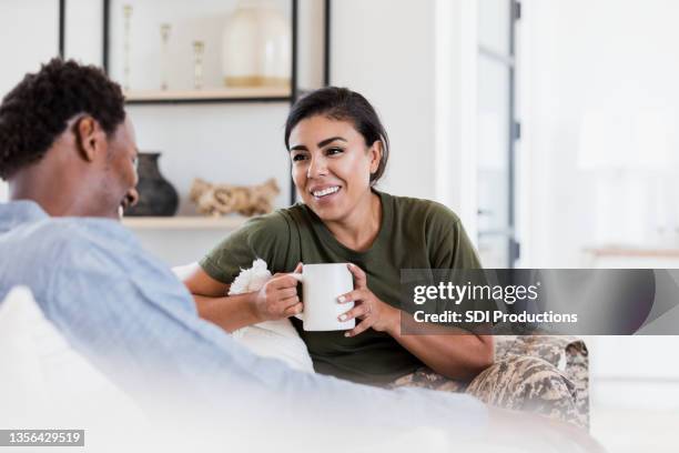 cozy couple enjoying time together - handsome military men stock pictures, royalty-free photos & images