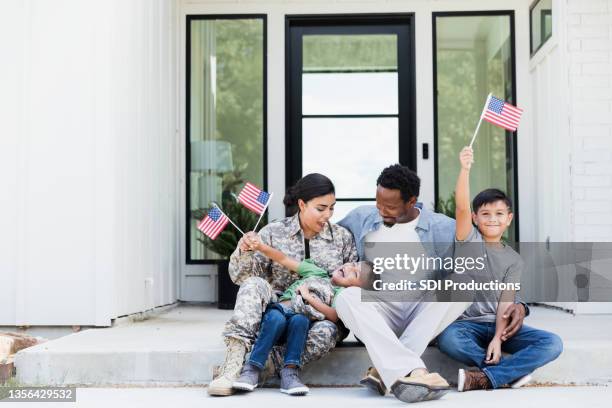 female soldier is excited to be home with her family - mother son reunited stock pictures, royalty-free photos & images