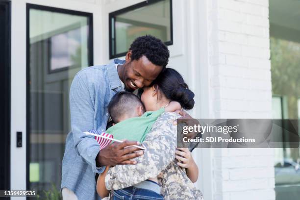 female soldier is reunited with family - homecoming stock pictures, royalty-free photos & images