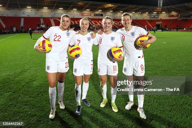 Alessia Russo, Beth Mead, Lauren Hemp and Ellen White of England pose for a photograph with their match balls after each of them scored a hat-trick...