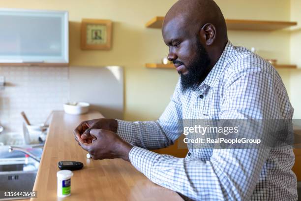 diabetic checking blood sugar levels. - diabetes pictures stock pictures, royalty-free photos & images