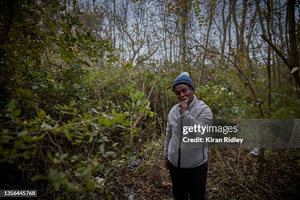 Migrant brushes his teeth in makeshift camp on the outskirts of Calais on November 30, 2021 in Calais, France. As winter closes in, migrants are...