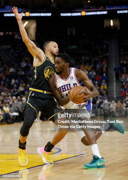 Golden State Warriors' Stephen Curry guards Philadelphia 76ers' Shake Milton in the fourth quarter of their NBA game at the Chase Center in San...
