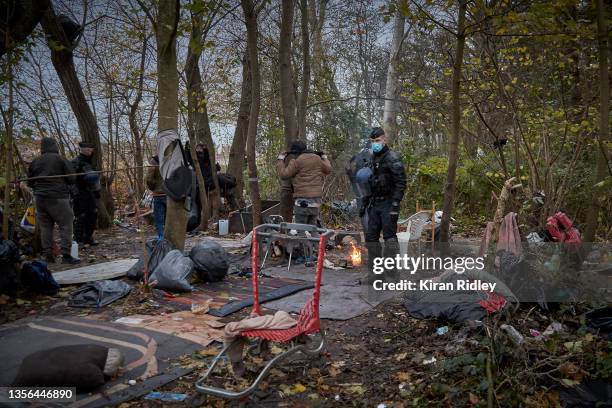 Police evict migrants from a makeshift camp at daybreak on the outskirts of Calais in the latest attempt to disperse migrants from gathering along...