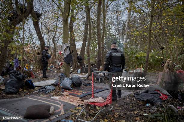 Police evict migrants from a makeshift camp at daybreak on the outskirts of Calais in the latest attempt to disperse migrants from gathering along...