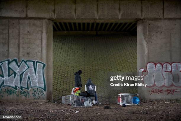 Migrants sit next to a railway line after being evicted from the Grande-Synthe migrant camp as police break up the camp in the latest attempt to...