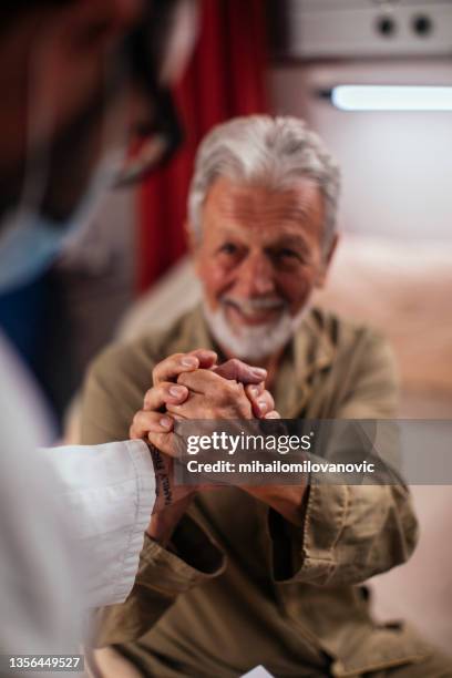 showing his gratitude of the way his doctor treated him - covid handshake stock pictures, royalty-free photos & images